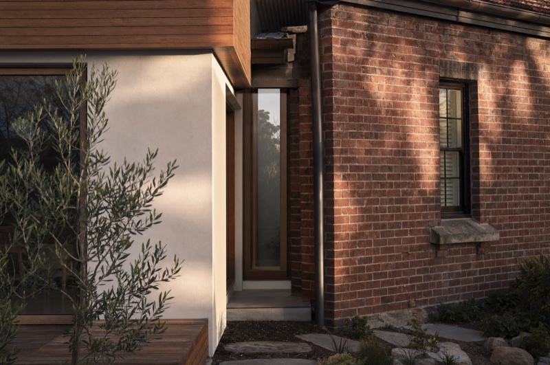 A first-floor addition where the new upper level meets the original home — illustrative concept